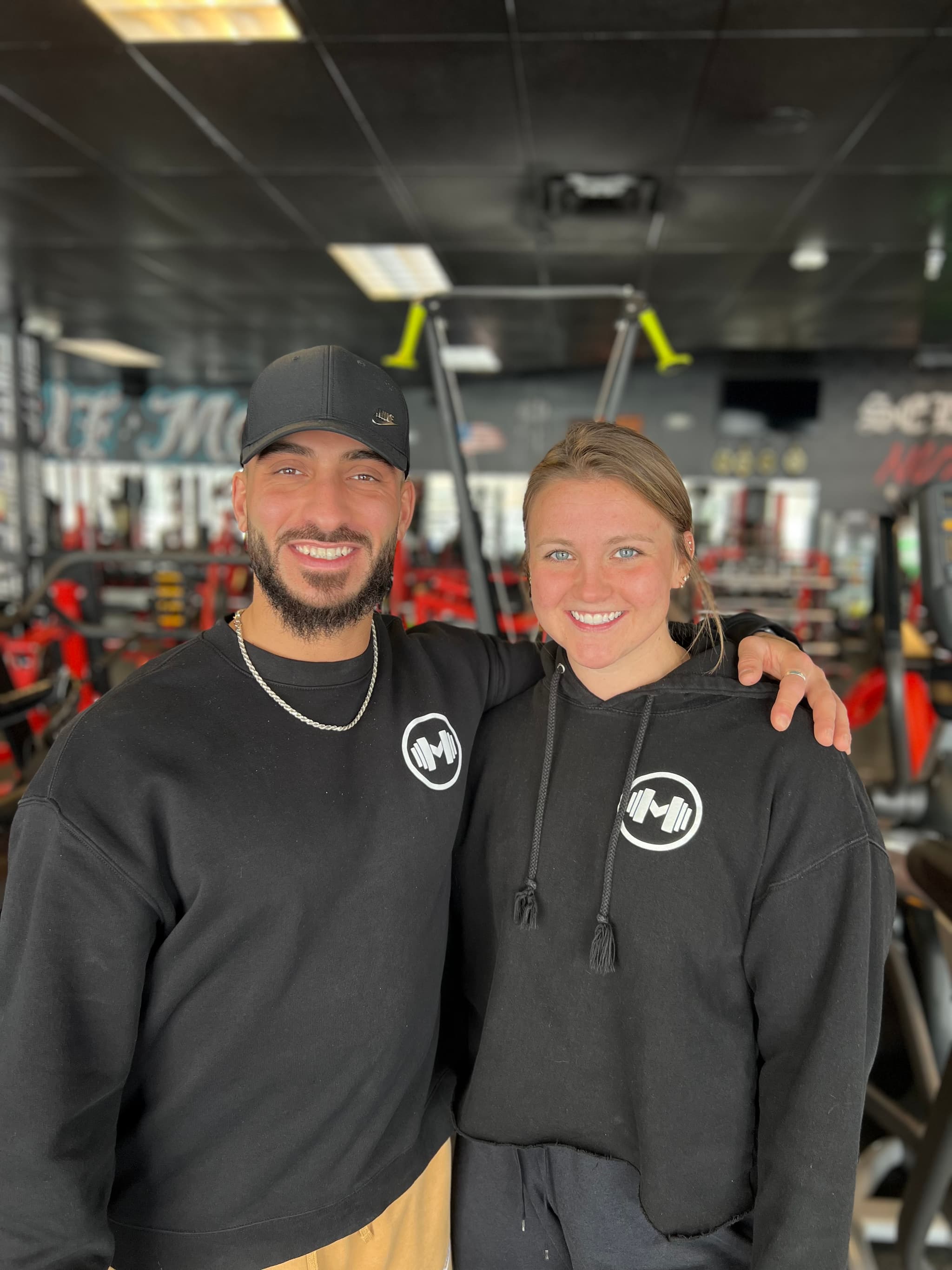 two trainers posing together